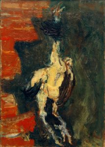 Gallina, appesa davanti a un muro di mattoni